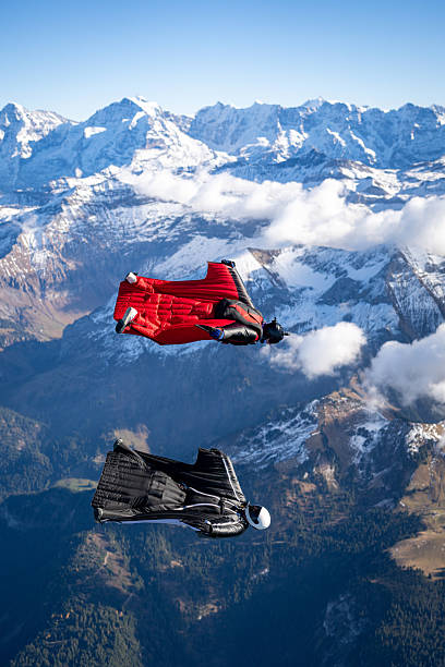 istock Wingsuit fliers fly side by side over snowcapped mountains 2249167661