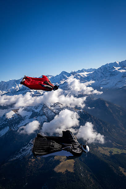 istock Wingsuit fliers fly side by side over snowcapped mountains 2249167666