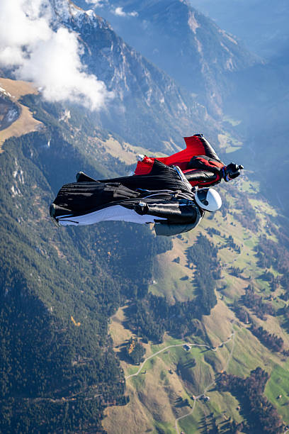 istock Wingsuit fliers fly side by side over snowcapped mountains 2249167673
