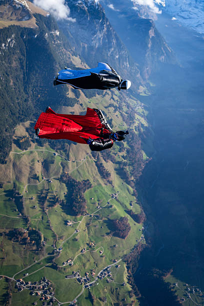 istock Wingsuit fliers fly side by side over snowcapped mountains 2249167693