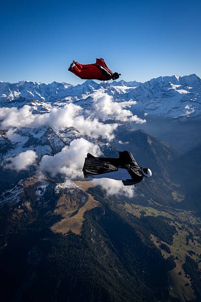 istock Wingsuit fliers fly side by side over snowcapped mountains 2249167700