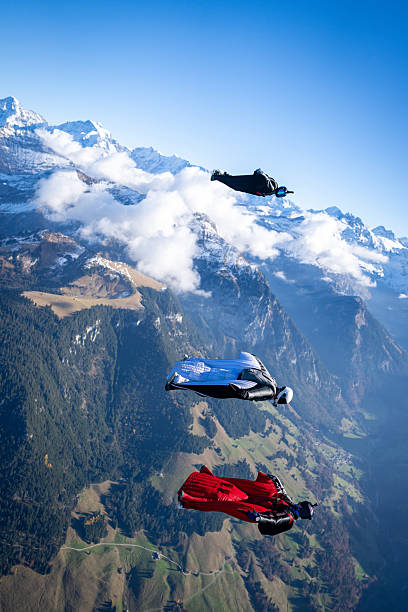 istock Wingsuit fliers fly side by side over snowcapped mountains 2249167707
