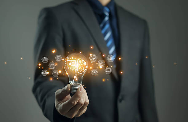 istock A businessman holding a glowing light bulb with AI icons, symbolizing artificial intelligence innovation, smart technology, future ideas, digital transformation, and advanced solutions. 2249167952