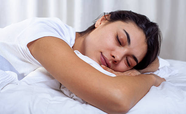 istock young woman sleeping on bed 2249168685