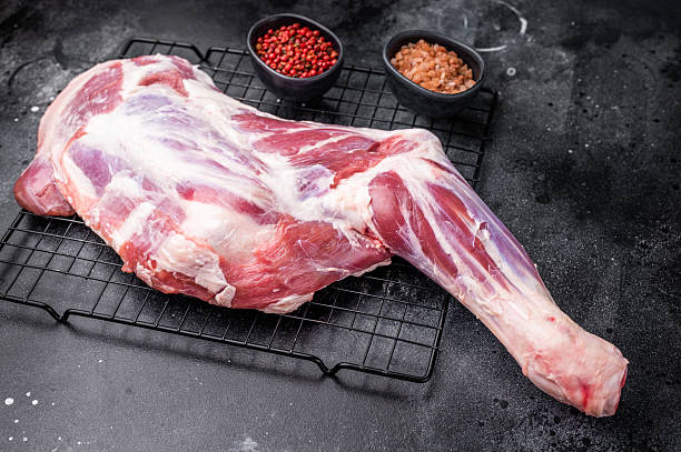 istock Fresh raw lamb shoulder, leg perfect for slow cooking or roasting to create a tender, flavorful meal. black background. top view 2249168876