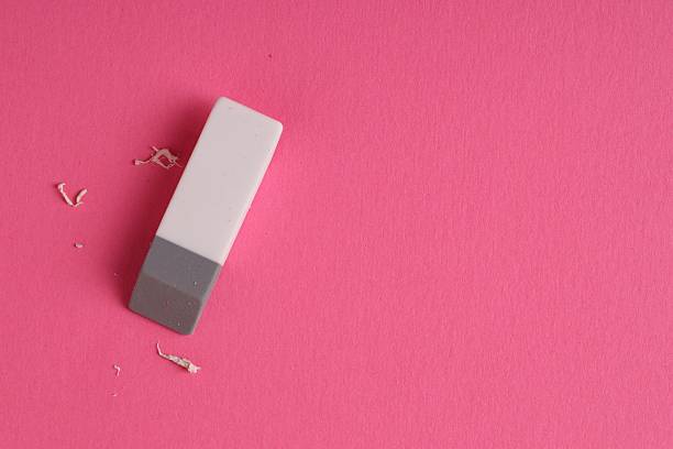 istock One eraser and scraps on pink background, top view. Space for text 2249169818