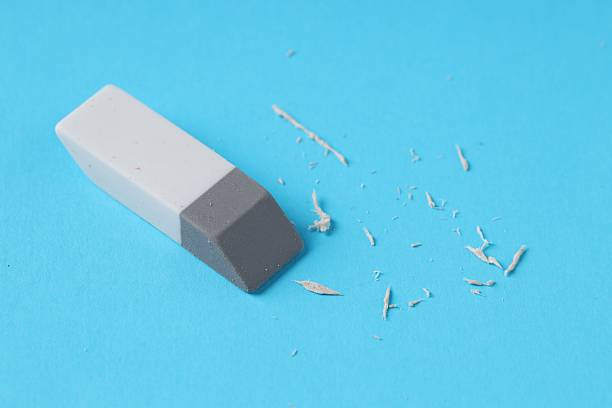 istock One eraser and scraps on light blue background, closeup 2249169829
