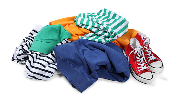 istock Pile of different used clothes isolated on white 2249170471
