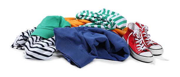 istock Pile of different used clothes isolated on white 2249170483