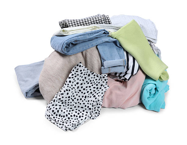 istock Pile of different used clothes isolated on white 2249170486