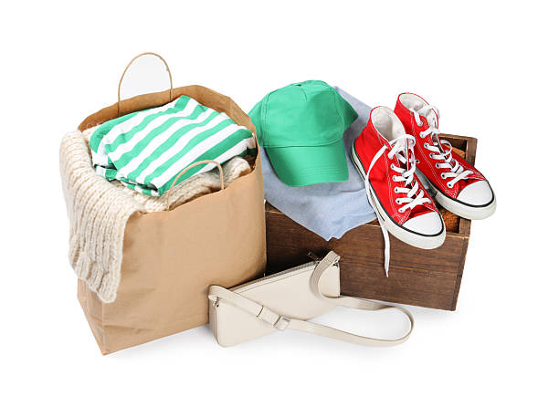 istock Packed used clothes, bag and shoes isolated on white 2249170494