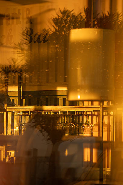 indoor scene reflected with gentle lighting, soft reflections capturing cozy morning ambiance scenes, images of interior illumination blending with morning reflections and foliage