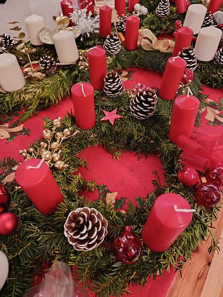 A festive, sustainable Christmas wreath with white candles made from fresh natural materials—a classic holiday decoration