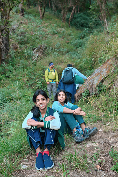 Smiling Kids Resting on a Forest Trail During a Hike in Uttarakhand, India