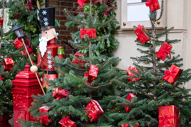 istock Christmas trees with red gift boxes and a wooden nutcracker create a fairytale festive decoration at the venue entrance 2249175088