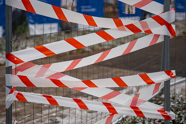 istock Warning tape on construction fence secures the work area and clearly marks restricted zones for pedestrians 2249175397