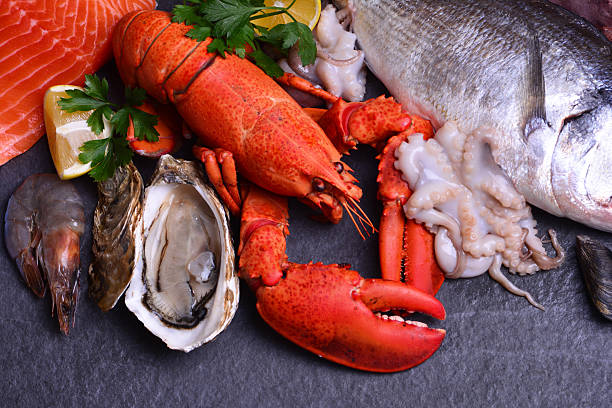 Freshly prepared and chopped shellfish including lobster, prawns, crab and clams on a fruit de mer platter at a restaurant in France
