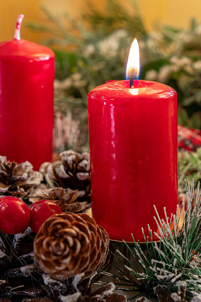 istock Bright red candles with pinecones and holiday decorations create a cozy atmosphere for a festive celebration during winter 2249177565