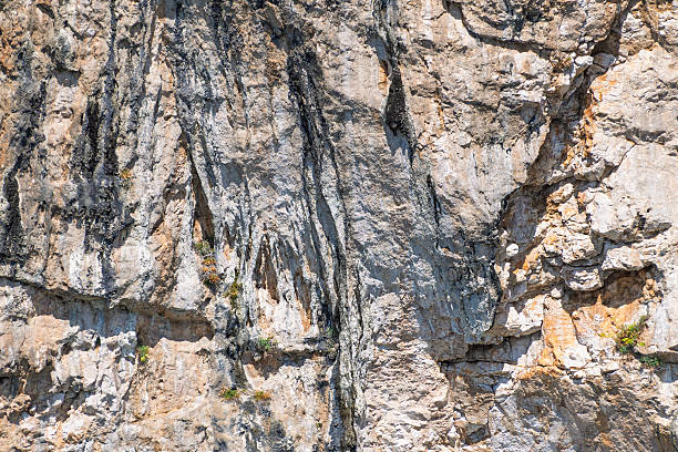 istock Rugged textured cliff face with distinct erosion patterns and varied rock colors 2249178459