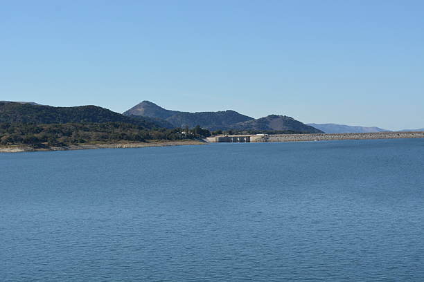 istock Serene Waters Reflect Mountains Under a Clear Blue Sky on a Peaceful Day by the Lake 2249179567
