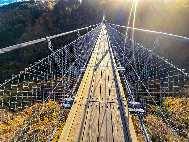 istock Autumn Crossing suspensionbridge autumn thrilling 2249180160