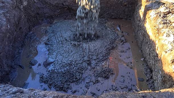istock Concreting work at the construction site. Construction workers pour liquid concrete from the concrete hopper into the formwork. 2249180325