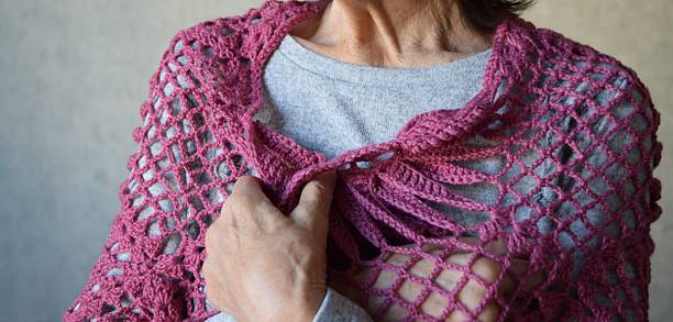 istock An elderly woman in warm clothes 2249181513