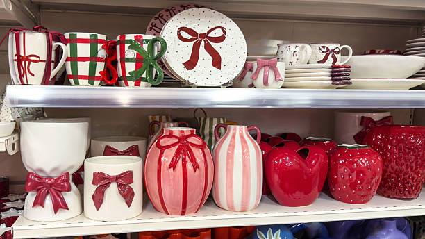 istock Festive ceramic tableware with bows and gift-themed designs displayed on store shelves. Colorful mugs, plates, vases, and decor items arranged in a holiday-inspired collection. 2249184811