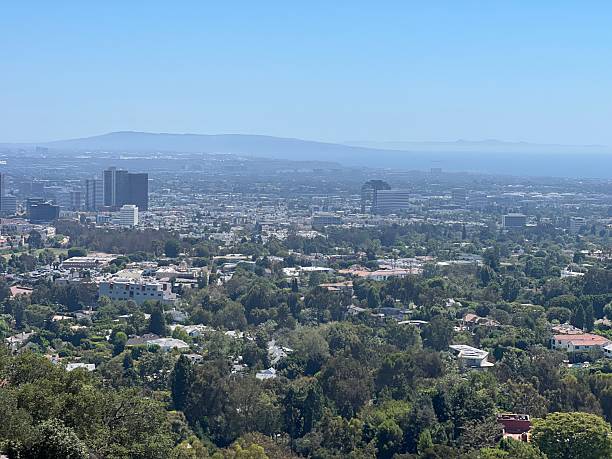 istock Overlooking a Bustling Cityscape From a Serene Hilltop on a Clear Day Reveals Endless Greenery and Urban Structures 2249185086
