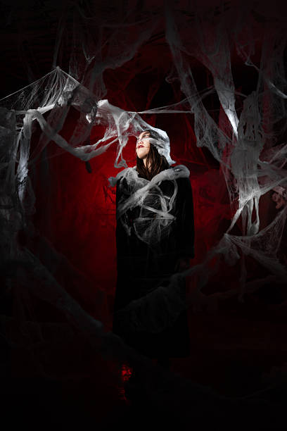istock vampire woman trapped spider web on red bloody background, sleeping in cocoon. 2249187194