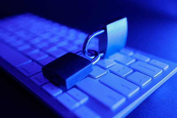 A padlock rests on a computer keyboard, symbolizing the critical need for cyber security in today's digital landscape. This scene emphasizes the ongoing battle for internet safety.