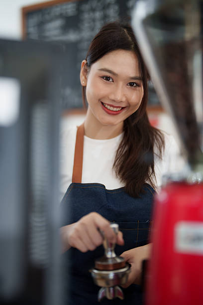 istock Asian barista smiling working at coffee shop serving coffee 2249188415