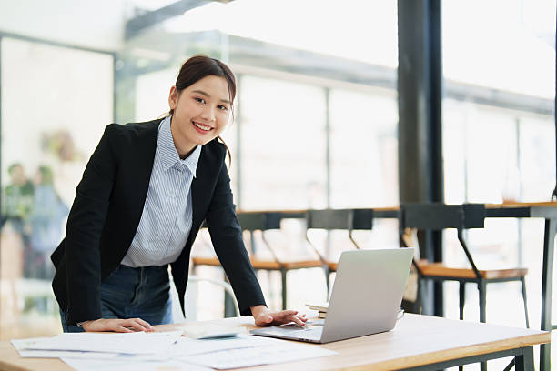istock Young businesswoman smiling while working with laptop in office 2249188944