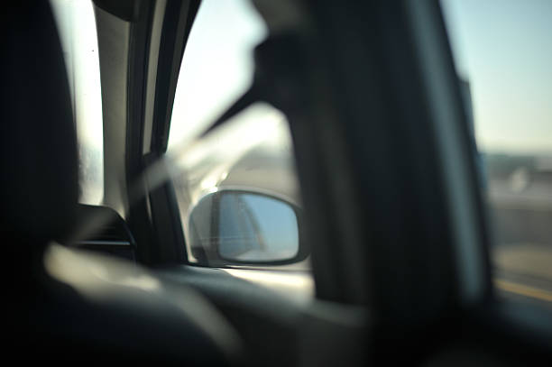istock View from the driver’s seat, hands on steering wheel perspective, dashboard and road ahead softly blurred 2249191502