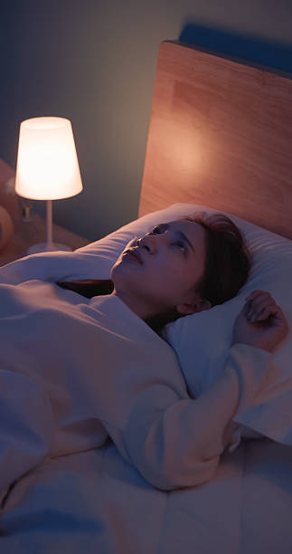 istock woman wakes up startled by nightmare 2249191653