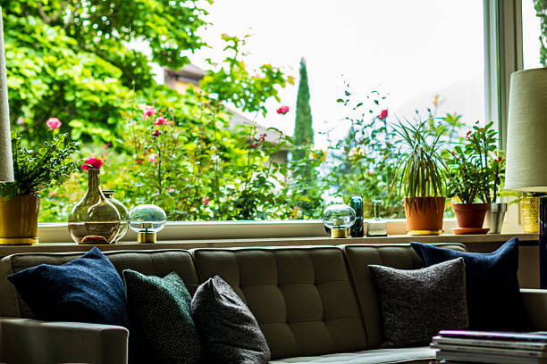 istock Cozy Living Room Interior with Large Windows and Plants 2249192110