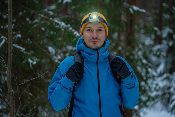 istock Hiker wearing headlamp exploring snowy forest at night 2249194225