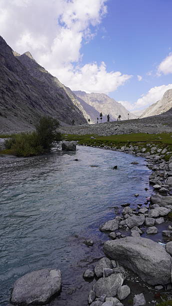 istock Scenic clear blue river flowing through rocky terrain with steep mountain slopes behind, clarity concept. 2249194923