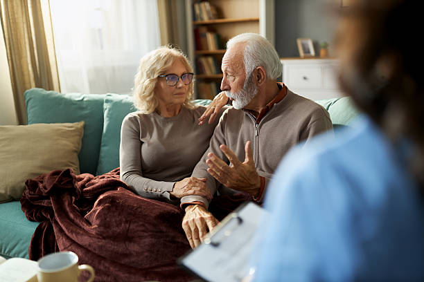 istock Senior couple talking to a doctor during her home visit. 2249196234