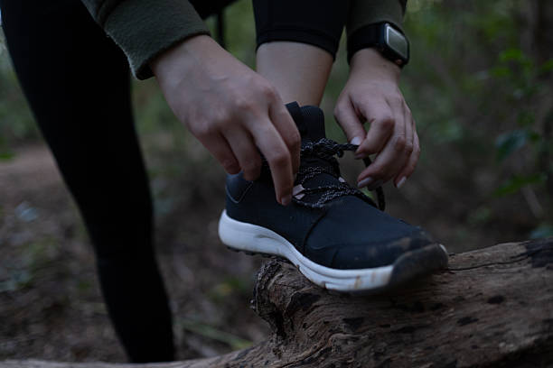 istock A person is putting on their shoes on a log 2249196451
