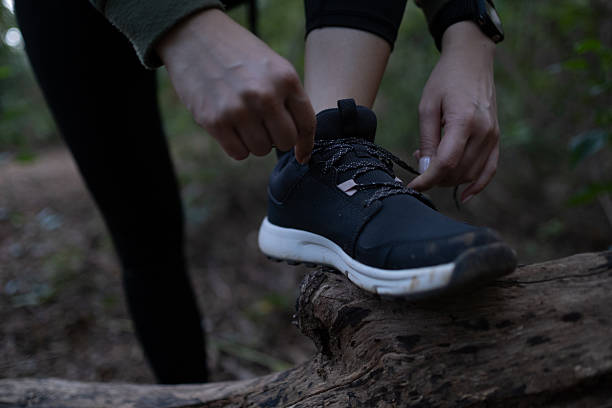 istock A person is putting on their shoes on a log 2249196458