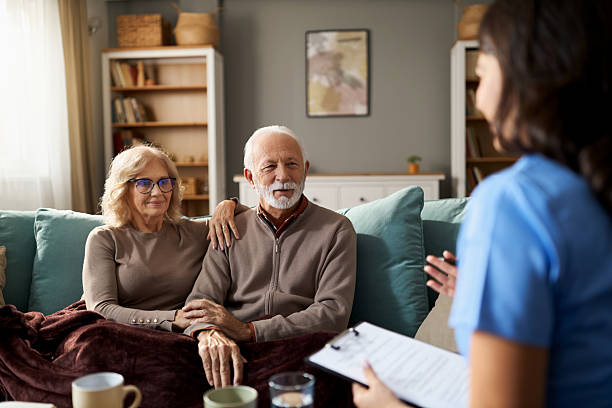 istock Smiling senior couple talking wih a  doctor during a home visit 2249196589