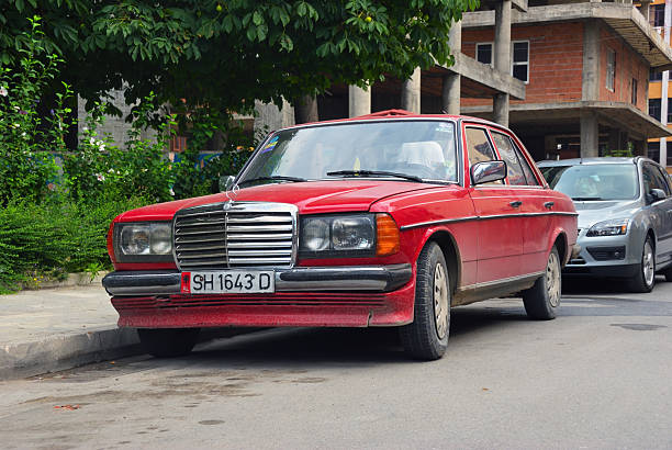 Shkoder, Albania - Aug 14, 2009: lassic red Mercedes-Benz W123 car shown on a city street