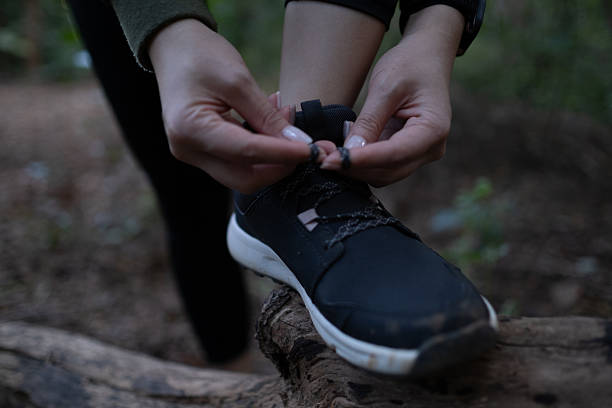istock A person is tying their shoe laces on a log 2249196852
