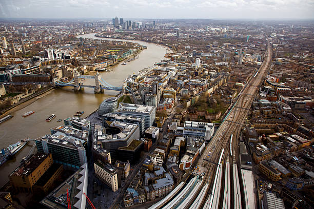 The View from above of the famous Tower Bridge over Thames river, HMS belfast ship and the modern architecture City Hall, London, England