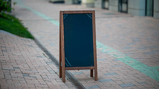 istock Blank wooden chalkboard stand placed on sidewalk 2249198094