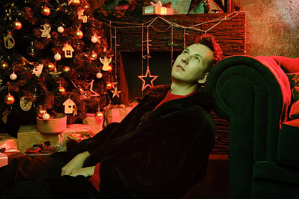 Man relaxes festive ambiance, Creative director ponders holiday decor
