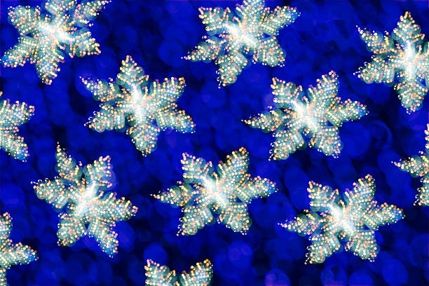 A charming handmade Christmas tree topper featuring a glittering wire star adorned with a vibrant blue crochet flower. Captured in soft, warm lighting against a moody backdrop, this festive close-up highlights the texture, craftsmanship, and cozy artistry of handmade holiday decorations. Perfect for seasonal features, craft showcases, and winter-themed imagery.