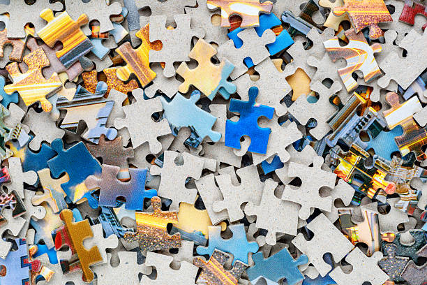 istock Jigsaw puzzle pieces.Colorful background with small puzzle pieces, messy.Some colored pieces of puzzle as background.Challenge and solution concept. Hobbies and leisure activities 2249204835