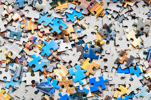 istock Jigsaw puzzle pieces.Colorful background with small puzzle pieces, messy.Some colored pieces of puzzle as background.Challenge and solution concept. Hobbies and leisure activities 2249204920